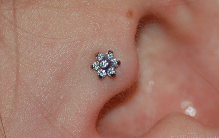 What a cute flower for her new piercing!