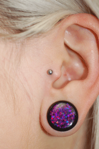 Check out her sparkly purple plugs she got here too